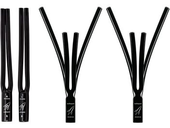 Four black plastic cable forks for audio cables, two different models, on a white background