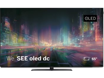 Televizorius Loewe We. SEE oled dc 65 colių, plokščias juodas ekranas su spalvingu miesto vaizdu, vaizdas iš priekio