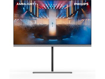 Philips 65OLED959 högupplöst TV i svart med tunn metallram, ljusgrå tygpanel nedtill med inbyggda högtalare och centralt placerat stativ i grått metall, sedd framifrån