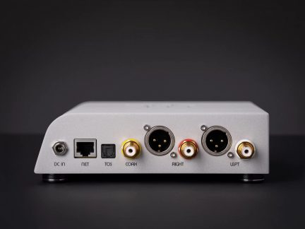 Rear view of a silver audio converter with network, optical, coaxial inputs and left and right XLR outputs