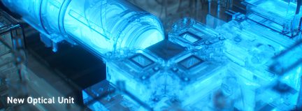Close-up view of a blue optical unit with cylindrical and rectangular components, diagonal angle