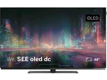Televizorius Loewe We. SEE oled dc 48 colių, vaizdas iš priekio, plonas juodas ekranas su ryškiu miesto vaizdu ir OLED logotipu