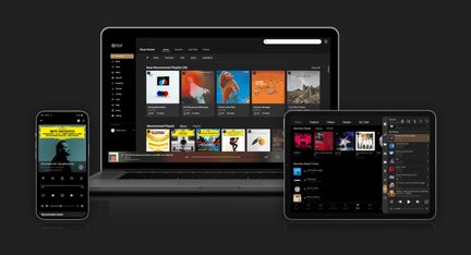 Black glass-and-metal smartphone, laptop, and tablet, front view, music app screens