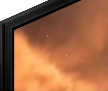 Televisor Sony BRAVIA 7 II K55XR7 negro, marco fino acanalado, vista en ángulo con pantalla en tonos naranjas