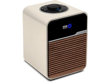 Ruark Audio R1S cream table radio, plastic casing, black front panel, slatted wood grille, three-quarter view