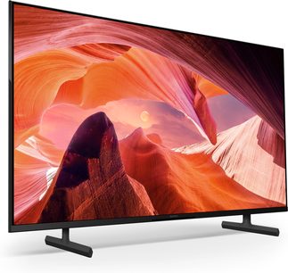 Sony KD75X80L fjernsyn med bred skærm, set fra trekvart vinkel, sort ramme, dobbeltstativ, billede af en orange og lyserød kløft