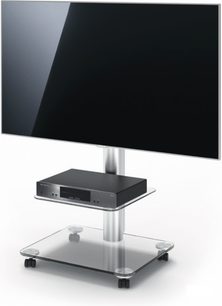 TV-møbel i glas og metal, sort fladskærm, set lidt fra siden forfra, på baggrund af gråt nedtonet til sort