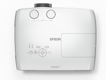 White Epson EH-TW7000 projector, front view, with two adjustment dials and several buttons on top