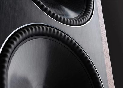 Paradigm Founder 80F floorstanding speaker in walnut finish. Close-up view of two concentric circular black and silver speakers