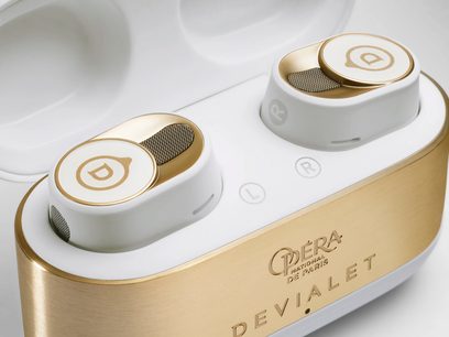 Devialet Gemini II fejhallgató Opéra de Paris, két fehér és arany színű fülhallgató arany színű töltőtokban