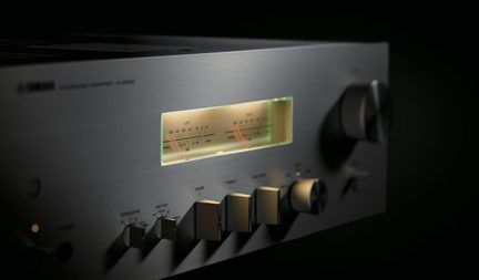 Yamaha stereo amplifier in brushed aluminum with backlit VU meter and large control knobs