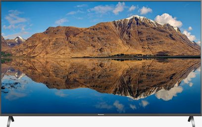 Panasonic TX-65FX700 fladskærms-TV, der viser et bjerglandskab spejlet i en sø, set forfra, rektangulær skærm, smal ramme
