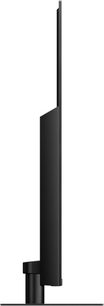 Panasonic TX-75JX940E-fladskærms-tv, set fra siden, lodret rektangulært sort fladskærms-panel på centralt sort fod