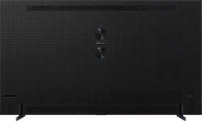 TCL 115C7K High-Definition-Fernseher in Schwarz mit gerasterter Kunststoffoberfläche, Rückansicht, zwei zentral angeordnete runde Lautsprecher und weit auseinanderstehende Metallfüße