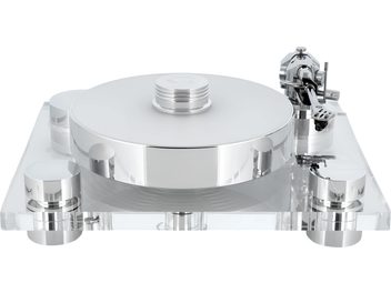 Transrotor Bellini RB330 silver and transparent hi-fi turntable, front view: circular polished metal platter with record clamp, clear acrylic base on four cylindrical feet, and chrome tonearm on the right