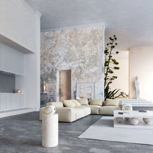 Moderní minimalistický bílý interiér s béžovou pohovkou, texturovanou stěnou, zelenou rostlinou, bílými sochami a velkým světlým otvorem
