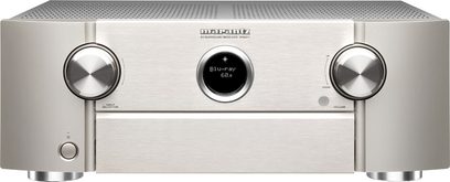 Marantz SR6011 sølv/gull hjemmekino-forsterker, frontvisning, sølvfarget front med knapper og blå LCD-skjerm i midten, to sølvfargede rattknotter på hver side