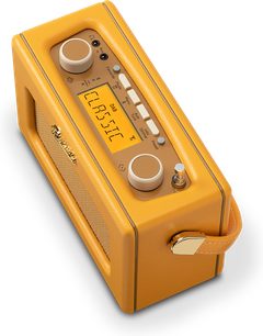 Radio Roberts Revival Uno BT gialla con custodia rettangolare in similpelle, vista dall'alto a tre quarti che rivela lo schermo LCD, due ghiere beige, una fila di pulsanti rettangolari e maniglia laterale con ferratura dorata