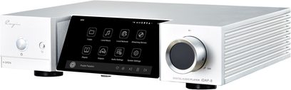 Cayin iDAP-8 network audio player in brushed silver aluminum, three-quarter front right view, featuring a large central black touchscreen, circular rotary knob on the right, branded left front panel, and finned right side panel