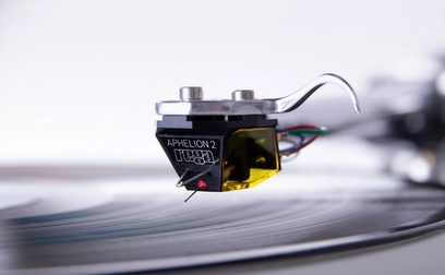 Rega Aphelion 2 MC sort-guld pickup set oppefra, tæt på, placeret på en sølvfarvet vinylplade