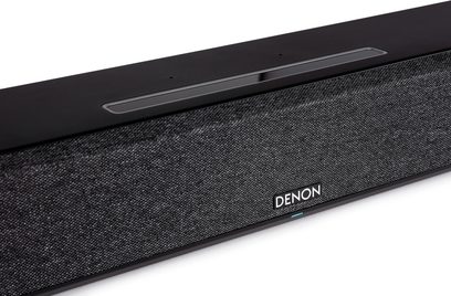 Denon Home 550 black soundbar, front view, fabric acoustic grille, metallic strip with centered logo