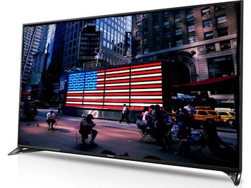 Panasonic TX-55CX800E 55-inch TV displaying a bright American flag on a skyscraper at night