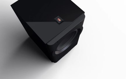 Black subwoofer, top-down view, smooth upper surface with central logo, circular speaker visible on the front.