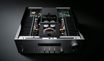 Silver Yamaha hi-fi stereo amplifier, open cover, internal components visible with central toroidal transformer